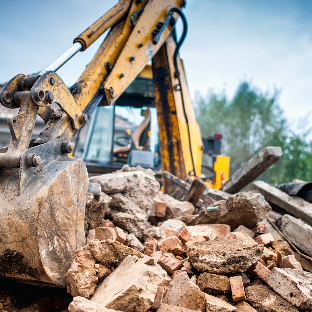 Hydraulic crusher excavator backoe machinery working on site demolition